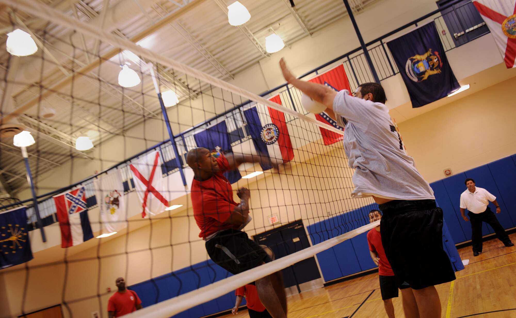 MOODY AIR FORCE BASE, Ga. -- Charles Oloster, 23rd Force Support Squadron volleyball team member, left, spikes the ball while Josh Lale, 723rd Aircraft Maintenance Squadron volleyball team member, right, attempts to block the spike during the base intramural volleyball championship here June 11. The 723rd AMXS won the championship in the first two games of a best out of three match. (U.S. Air Force photo by Senior Airman Gina Chiaverotti)