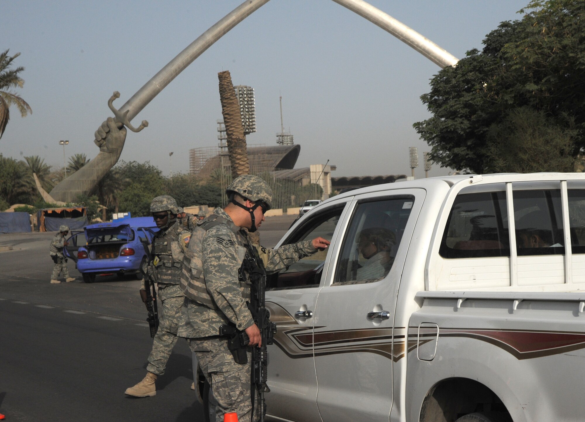 INTERNATIONAL ZONE, Baghdad, Iraq -- Members of the 732nd Expeditionary Security Forces Squadron, Detachment 4, perform traffic control point checks in the International Zone May 28. The TCPs are only one tool the defenders use to patrol and protect the IZ. (U.S. Air Force photo/Tech. Sgt. Amanda Callahan)