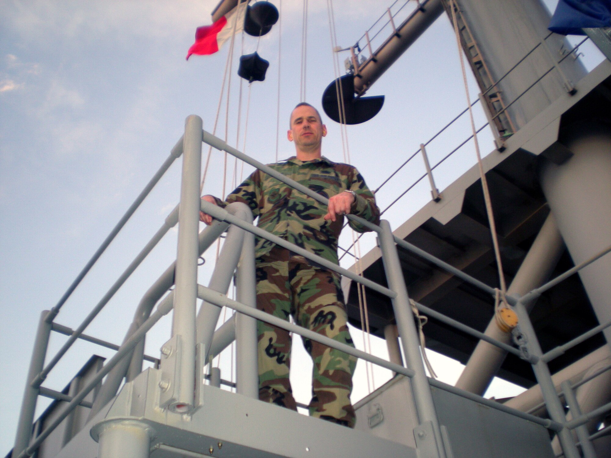 Tech. Sgt. Joseph Jones, from the U.S. Air Force Expeditionary Center's Air Mobility Battlelab at Fort Dix, N.J., has a photo taken of him aboard the U.S. Navy's U.S.S. Boxer - a Wasp-class amphibious assault ship May 4, 2008.  Sergeant Jones is serving aboard the Boxer as a Spanish language translator as the ship participates in Operation Continuing Promise 2008 visiting countries such as El Salvador, Guatemala and Peru.  (U.S. Air Force Photo)