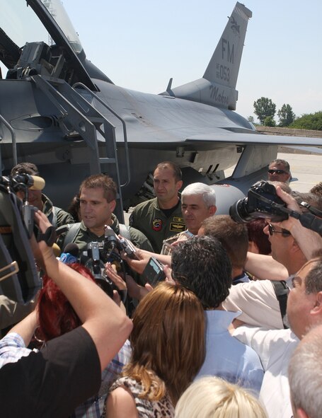 GRAF IGNATIEVO AIR BASE, BULGARIA - Nicolay Tsonev (center), the Bulgarian Minister of Defense, talks with Bulgarian media representatives before taking off on an Orientation Flight flown by Lt. Col. Jose Monteagudo, 93rd Fighter Squadron commander, on June 11. Approximately 200 reservists and 10 F-16 fighter jets from Homestead Air Reserve Base are currently on a two-week deployment to Bulgaria to train with the Bulgarian Air force. (U.S. Air Force photo by Tech. Sgt. Bucky Parrish)