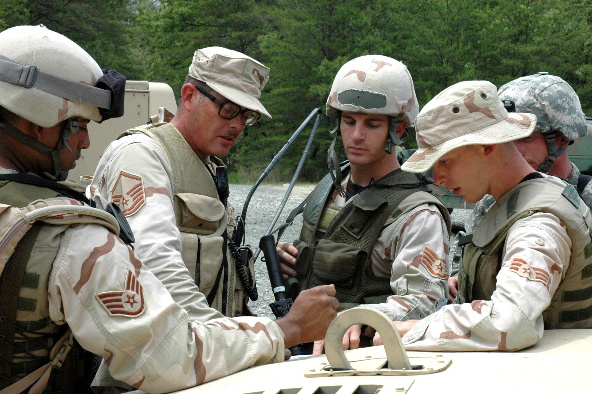 Master Sgt. Warren Booker, 49th Security Forces Squadron, Holloman Air Force Base, N.M., leads a group of fellow students in the Air Force Phoenix Warrior Training Course 08-5 in planning for a mounted patrol (convoy) during training on a Fort Dix, N.J., range June 6, 2008.  The course, taught by the U.S. Air Force Expeditionary Center's Expeditionary Operations School and 421st Combat Training Squadron, prepares security forces Airmen for upcoming deployments.  (U.S. Air Force Photo/Staff Sgt. Paul R. Evans)