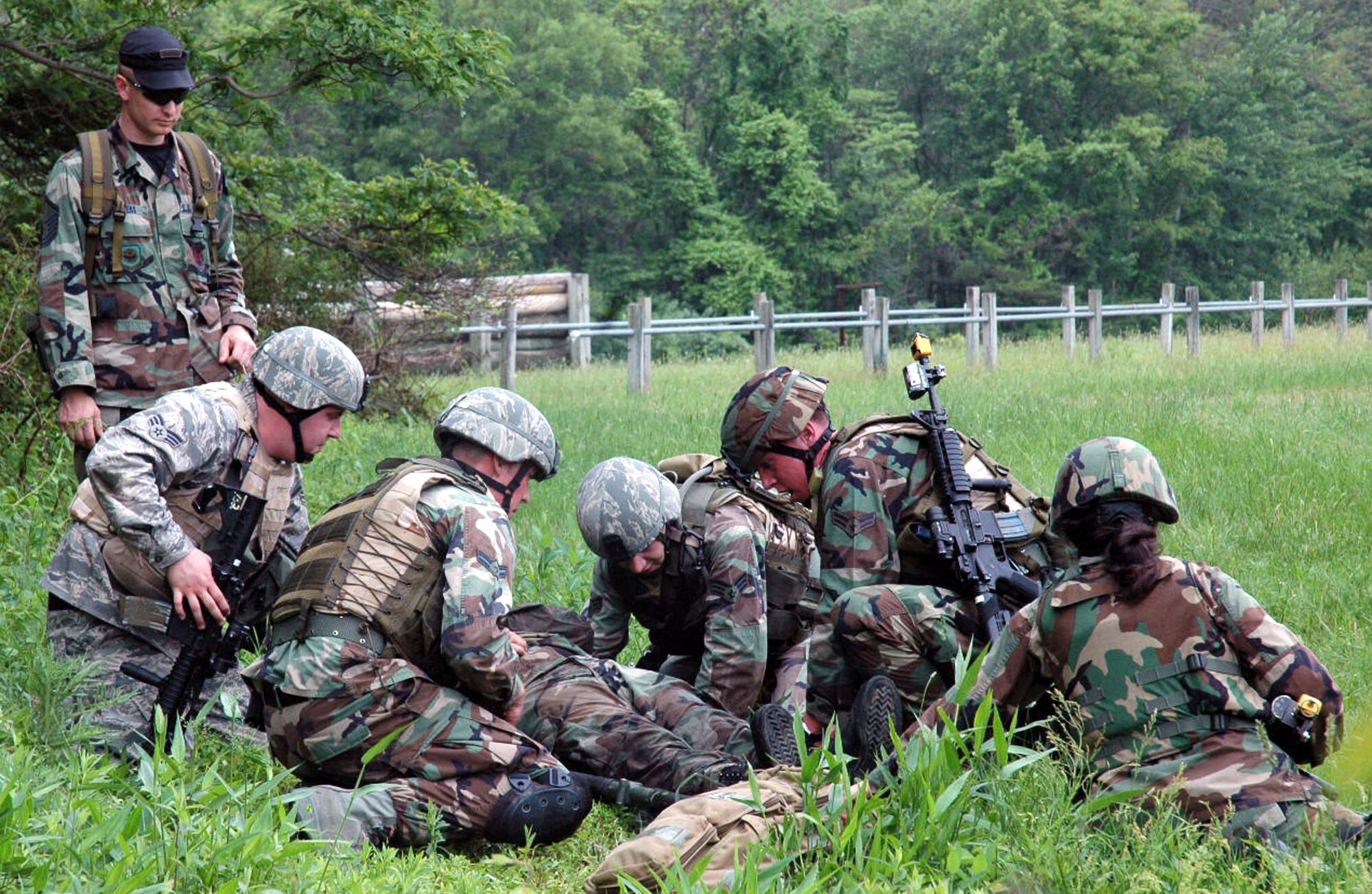 Instructor Master Sgt. Colby Bowers observes students in the Air Force Phoenix Warrior Training Course 08-5 prepare a "victim" for transport during training in a combat first aid class on a Fort Dix, N.J., range June 5, 2008.  The course is taught by the U.S. Air Force Expeditionary Center's Expeditionary Operations School and 421st Combat Training Squadron and prepares security forces Airmen for upcoming deployments. Annually, the USAF EC trains more than 23,000 students in expeditionary- and mobility air force-based courses both with in-residence and distance learning.  (U.S. Air Force Photo/Staff Sgt. Paul R. Evans)