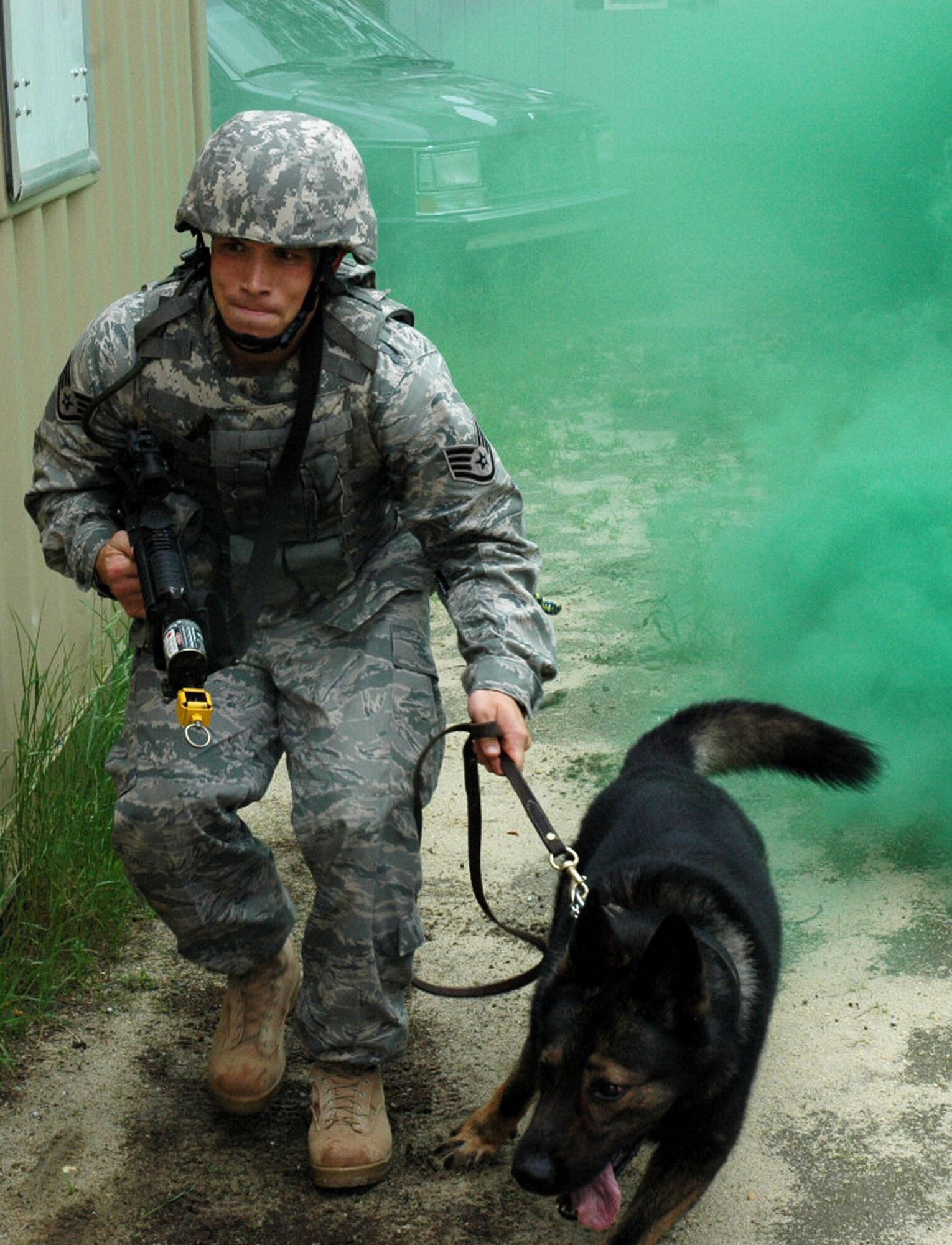 Staff Sgt. Clifford Hartley and his military working dog, Cir, both from the 437th Security Forces Squadron, Charleston Air Force Base, S.C., participate in canine military operations in urban terrain training June 5, 2008, at Naval Air Engineering Station Lakehurst, N.J.  Their training was part of the Air Force Phoenix Warrior Course 08-5 which trains security forces for upcoming deployments.  The course is operated by the U.S. Air Force Expeditionary Center at Fort Dix, N.J.  (U.S. Air Force Photo/Staff Sgt. Paul Evans)