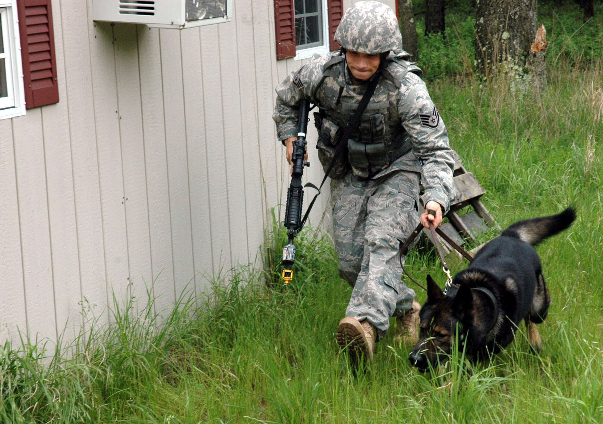 Staff Sgt. Clifford Hartley and his military working dog, Cir, both from the 437th Security Forces Squadron, Charleston Air Force Base, S.C., participate in canine military operations in urban terrain training June 5, 2008, at Naval Air Engineering Station Lakehurst, N.J.  Their training was part of the Air Force Phoenix Warrior Course 08-5 which trains security forces for upcoming deployments.  The course is operated by the U.S. Air Force Expeditionary Center at Fort Dix, N.J.  (U.S. Air Force Photo/Staff Sgt. Paul Evans)
