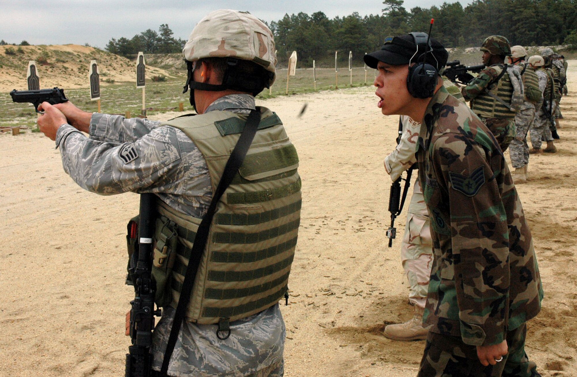 Staff Sgt. Brian Arrington, an instructor from the U.S. Air Force Expeditionary Center's 421st Combat Training Squadron, watches students in the Air Force Phoenix Warrior Training Course 08-5 practice live-fire combat rifle training on a range on Fort Dix, N.J., June 5, 2008.  The course prepares security forces Airmen for upcoming deployments.  Annually, more than 23,000 students are trained at the USAF EC through in-residence and distance learning courses.  (U.S. Air Force Photo/Staff Sgt. Paul Evans)