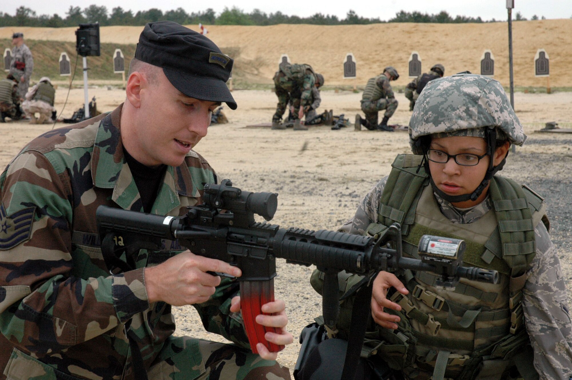 Tech. Sgt. Dan Williamson, an instructor from the U.S. Air Force Expeditionary Center's 421st Combat Training Squadron, helps a student in the Air Force Phoenix Warrior Training Course 08-5 prepare for live-fire combat rifle training on a range on Fort Dix, N.J., June 5, 2008.  The course prepares security forces Airmen for upcoming deployments.  Annually, more than 23,000 students are trained at the USAF EC through in-residence and distance learning courses.  (U.S. Air Force Photo/Staff Sgt. Paul Evans)