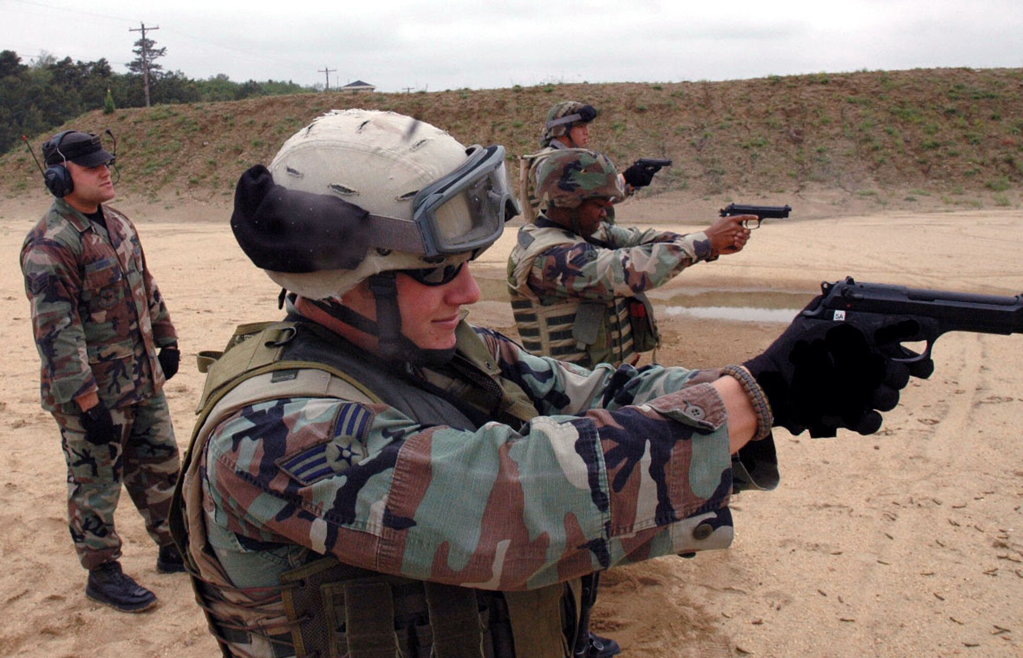 Staff Sgt. Thomas Carpino, an instructor from the U.S. Air Force Expeditionary Center's 421st Combat Training Squadron, watches students in the Air Force Phoenix Warrior Training Course 08-5 practice live-fire combat rifle training in a range on Fort Dix, N.J., June 5, 2008.  The course prepares security forces Airmen for upcoming deployments.  Annually, more than 23,000 students are trained at the USAF EC through in-residence and distance learning courses.  (U.S. Air Force Photo/Staff Sgt. Paul Evans)