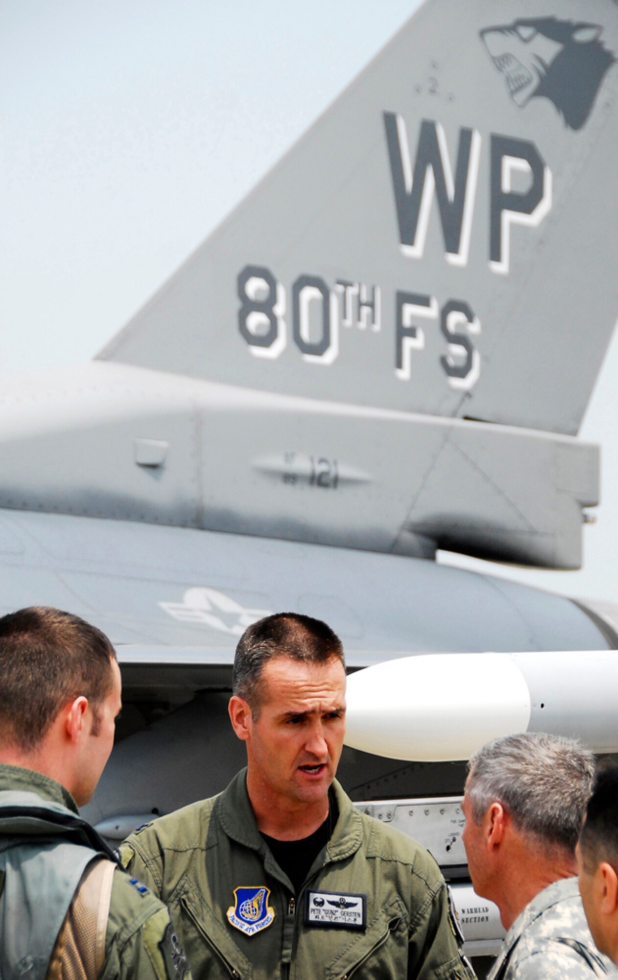 KUNSAN AIR BASE, Republic of Korea -- U.S. Air Force Colonel Pete Gersten, 8th Operations Group Commander and Captain Brian Kellam, a pilot with the 80th Fighter Squadron, explain details about the F-16 Falcon to U.S. Army General Walter Sharp, United States Forces Korea Commander, during his visit here June 13.  Gen. Sharp recently took command of USFK and is visiting various areas throughout Korea.  (U.S. Air Force photo/Tech. Sgt. Quinton T. Burris) 