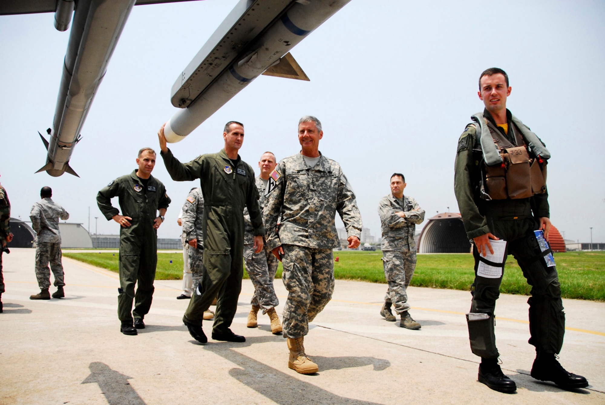 KUNSAN AIR BASE, Republic of Korea -- U.S. Air Force Captain Brian Kellam, a pilot with the 80th Fighter Squadron, and Colonel Pete Gersten, 8th Operations Group Commander, explain details about the F-16 Falcon to U.S. Army General Walter Sharp, United States Forces Korea Commander, during his visit here June 13.  Gen. Sharp recently took command of USFK and is visiting various areas throughout Korea.  (U.S. Air Force photo/Tech. Sgt. Quinton T. Burris) 