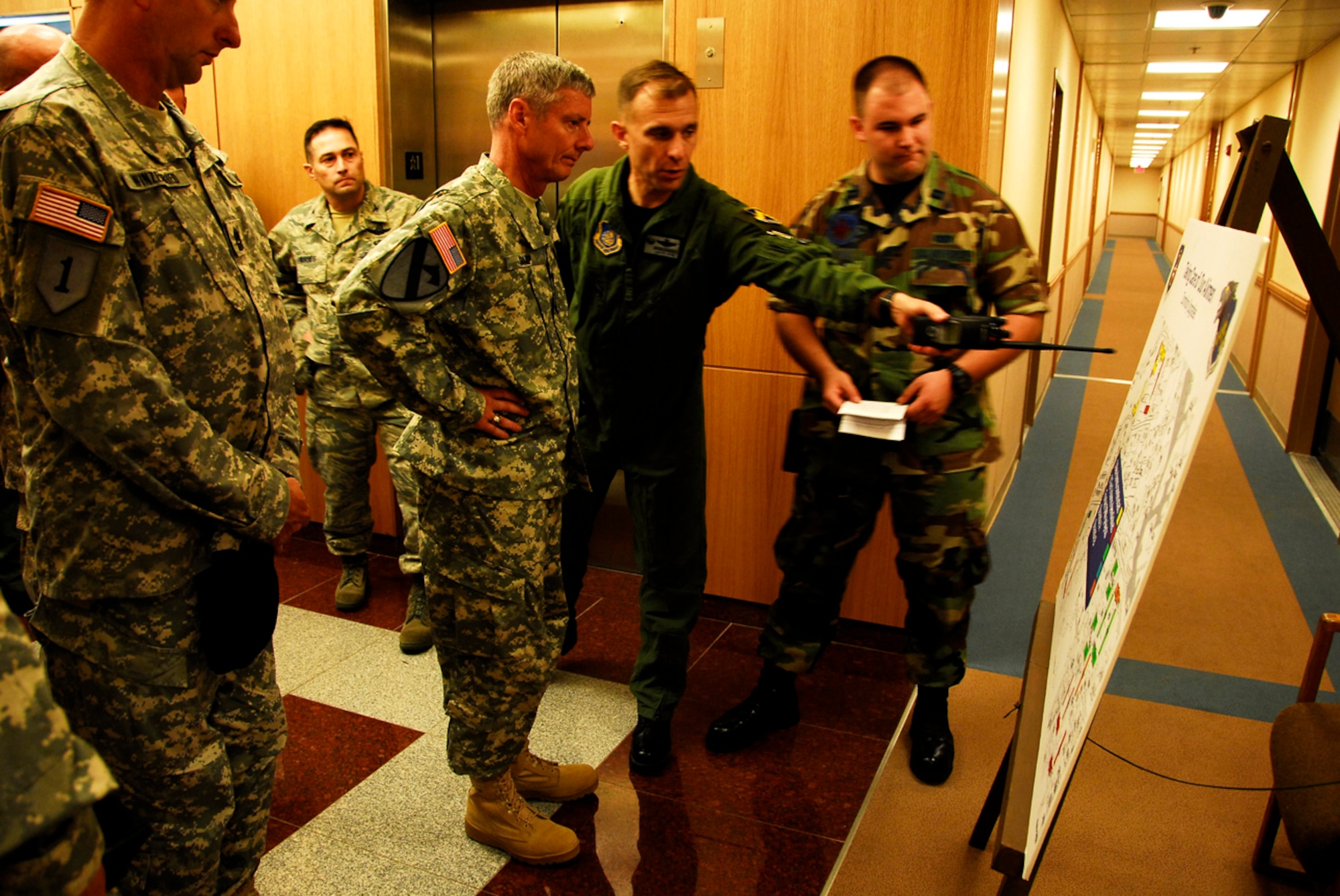 KUNSAN AIR BASE, Republic of Korea -- U.S. Army General Walter Sharp, United States Forces Korea Commander, is briefed by Colonel Bryan Bearden, 8th Fighter Wing Commander, and Captain Joseph Wierenga, 8 Civil Engineer Squadron Chief of Plans, about upcoming quality of life improvements here June 13.  Gen. Sharp recently took command of USFK and is visiting various areas throughout Korea.  (U.S. Air Force photo/Tech. Sgt. Quinton T. Burris) 