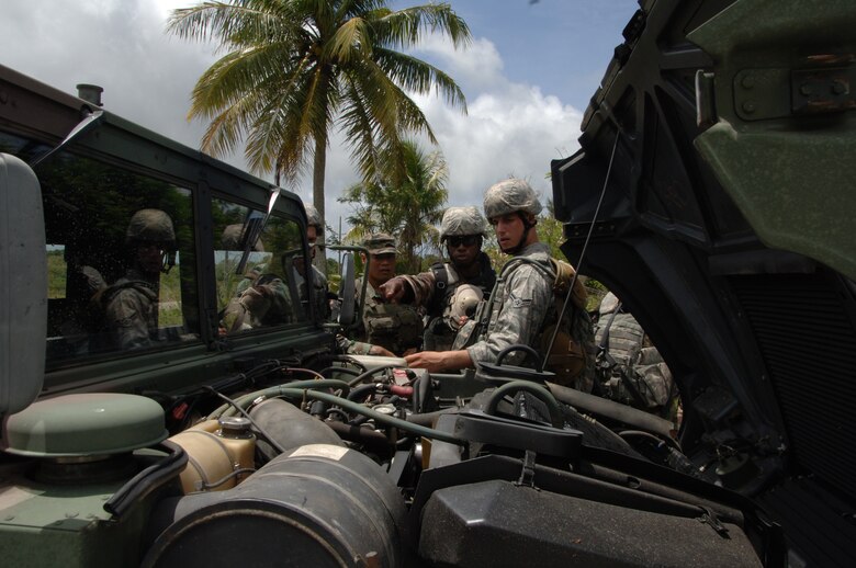 PACAF Security Forces Airmen do a walk through vehicle inspection at Andy South on Andersen Air Force Base, June 14. The Airmen followed Air Force form 1800, to familiarize themselves with the functions of the vehicle and the combat inspection worksheet with Cadre, Staff Sergeant Knight from  the 736th SF. (U.S. Air Force photo by Airman First Class Courtney Witt)