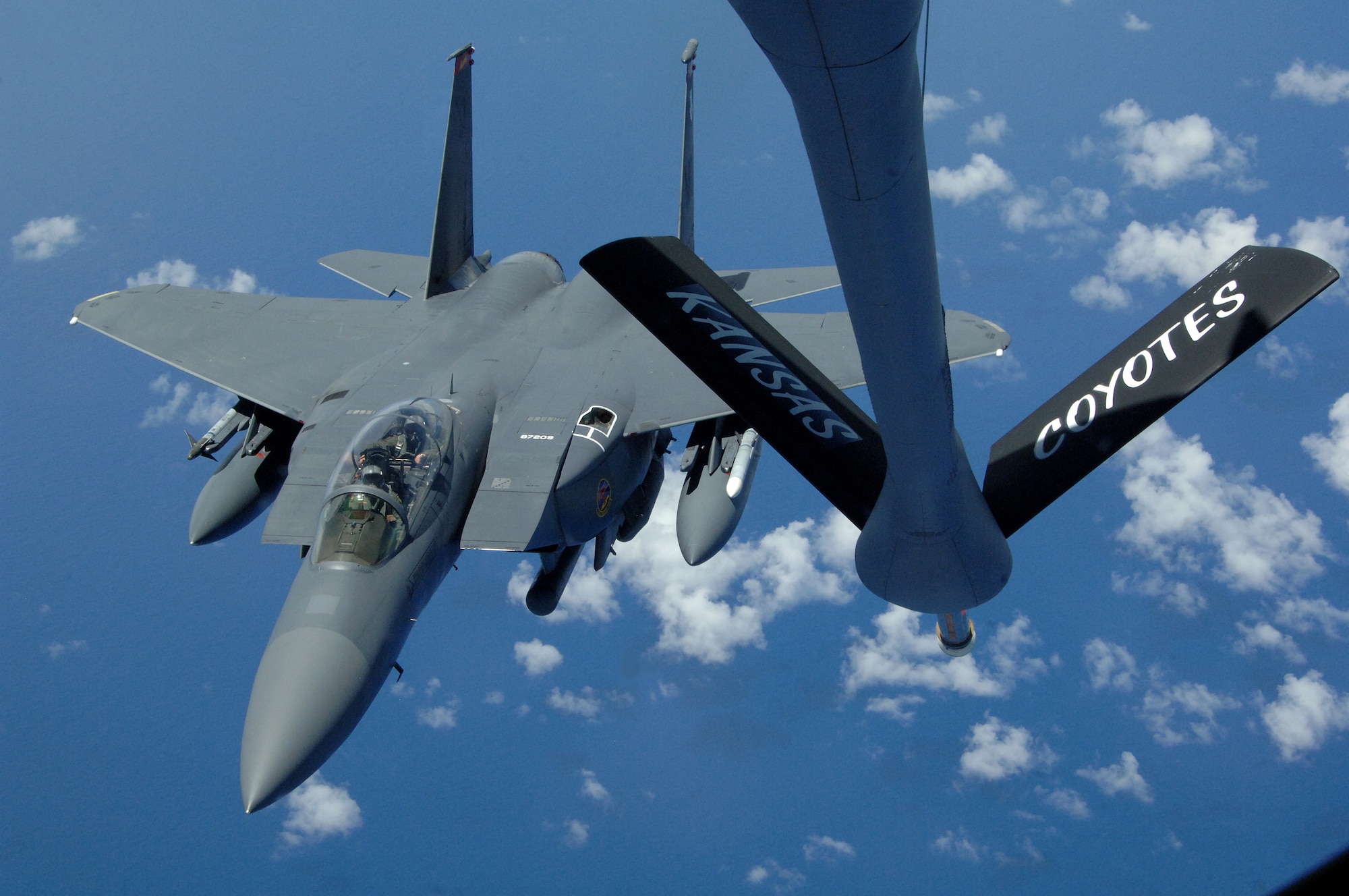 A U.S. Air Force F-15E Strike Eagle from Mountain Home Air Force Base, Idaho, approaches the boom for refueling high above the pacific by a KC-135 Stratotanker from the 117th Air Refueling Squadron, Forbes Field Air National Guard Base, Topeka Kan. Both took off from Andersen Air Force Base, Guam on June 12. (U.S. Air Force photo by Airman 1st Class Courtney Witt)