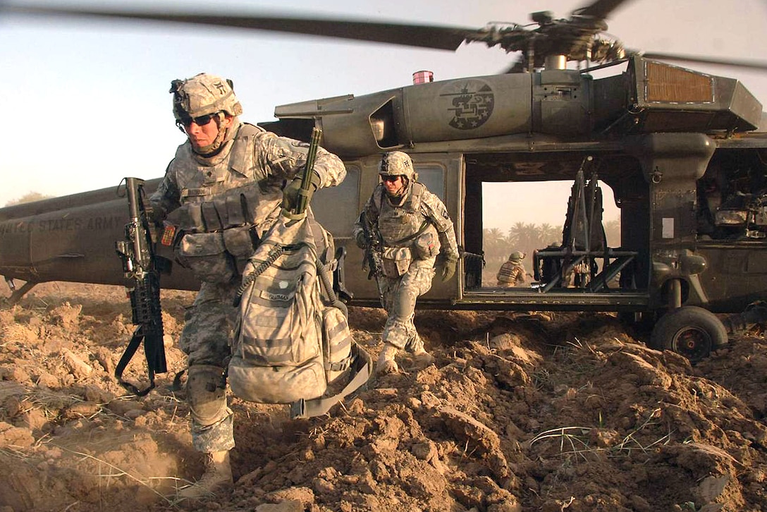 U.S. Army Spc. Guzman departs a Blackhawk helicopter and begins an air assault mission in Ludifiyah, Iraq, June 14, 2008. The soldiers are assigned to the 101st Airborne Division's 320th Battalion, 3rd Brigade Combat Team.
