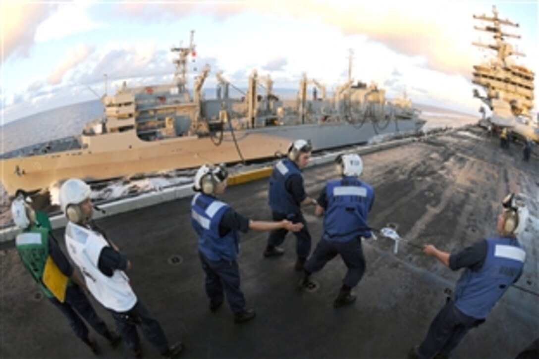 Sailors assigned to the aircraft carrier USS Ronald Reagan handle the phone line during a replenishment at sea with Military Sealift Command fast combat support ship USNS Bridge, Philippine Sea, June 14, 2008. Although the USS Ronald Reagan is nuclear powered, the ship must have fuel for embarked Carrier Air Wing 14 to fly missions. 