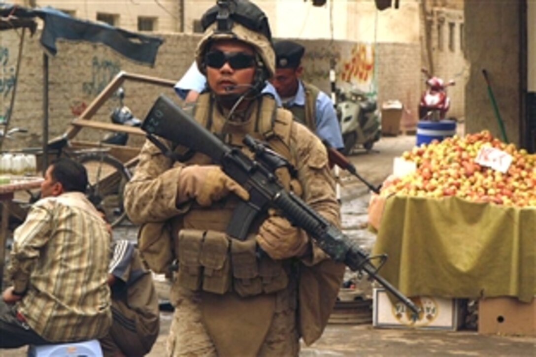 U. S. Navy Petty Officer 2nd Class Giovanni Lozano patrols the market area of Ramadi, Iraq, locally known as the souk, June 9, 2008. Lozano is assigned to 1st Battalion, 9th Marine Regiment, Regimental Combat Team 1. This former insurgent stronghold is enjoying a remarkable return to peace and prosperity. 