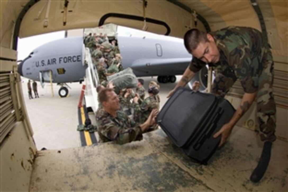 Members of the Iowa Air National Guard's 185th Air Refueling Wing unload their gear at the Eastern Iowa Airport in Cedar Rapids, Iowa, June 15, 2008. State officials activated the National Guard to the help with recovery efforts after massive flooding caused evacuations from towns along major rivers.