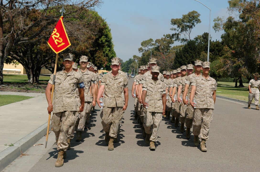 Lance Cpl. Robert E. Gebhardt, Platoon 3221, Company K, performs his duty as platoon guide and carries his platoon’s guidon at the front of the formation as the platoon marches to Shepherd Memorial Drill Field for graduation practice, June 16. Gebhardt was meritoriously promoted to lance corporal when he was selected as Co. K honorman.