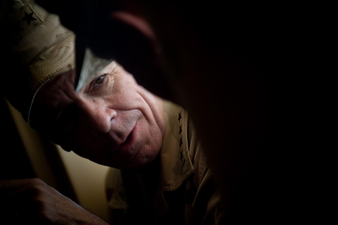 Adm. Mike Mullen, chairman of the Joint Chiefs of Staff, speaks with a Marine training at the 30-day pre-deployment exercise Mojave Viper.