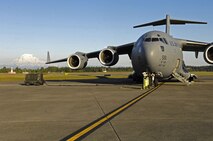 Mount Rainier can be seen behind a C-17 Globemaster parked on the flightline at McChord Air Force Base, Wash., on June 15, 2008. The jet belongs to the 15th Airlift Wing at Hickam Air Force Base, Hawaii. A crew of active duty Airmen and Hawaii Air National Guardsmen are taking Airmen and equipment from McChord AFB to Ramstein Air Base, Germany. From there, an Air Mobility Command crew will take the jet to Balad Air Base, Iraq, completing the delivery of the passengers and equipment in support of the global war on terror. (US Air Force photo / Tech. Sgt. Chris Vadnais)
