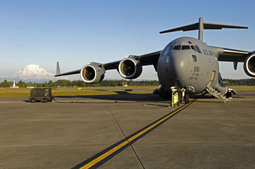 Mount Rainier can be seen behind a C-17 Globemaster parked on the flightline at McChord Air Force Base, Wash., on June 15, 2008. The jet belongs to the 15th Airlift Wing at Hickam Air Force Base, Hawaii. A crew of active duty Airmen and Hawaii Air National Guardsmen are taking Airmen and equipment from McChord AFB to Ramstein Air Base, Germany. From there, an Air Mobility Command crew will take the jet to Balad Air Base, Iraq, completing the delivery of the passengers and equipment in support of the global war on terror. (US Air Force photo / Tech. Sgt. Chris Vadnais)

