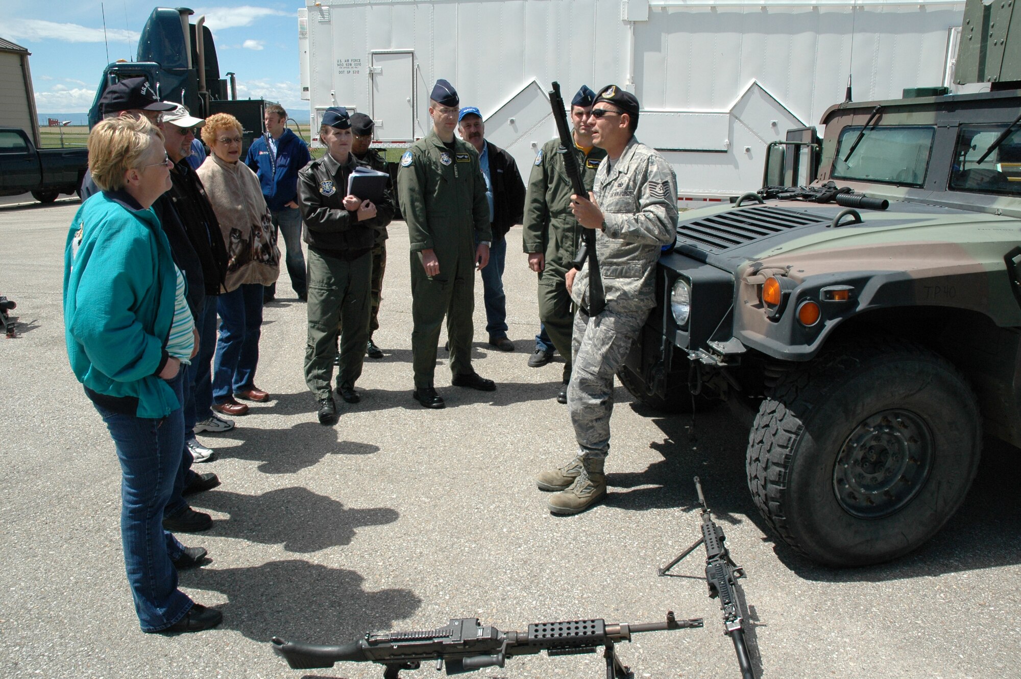 Tech. Sgt. Richard Paternoster, Combat Arms Training and Maintenance NCO in charge, describes various small arms to local elected officials and local news affiliates during an open house at Mike-01 June 13. (U.S. Air Force photo/Airman 1st Class Dillon White)