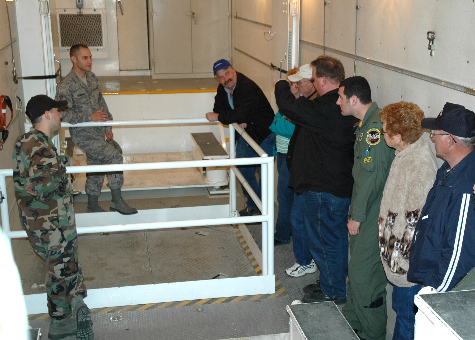 Members of the 341st Missile Maintenance Squadron describe their role in the strategic deterrent mission and showcase their equipment inside a payload transporter during an open house for local elected officials and local news affiliates at Mike-01 June 13. (U.S. Air Force photo/Airman 1st Class Dillon White)