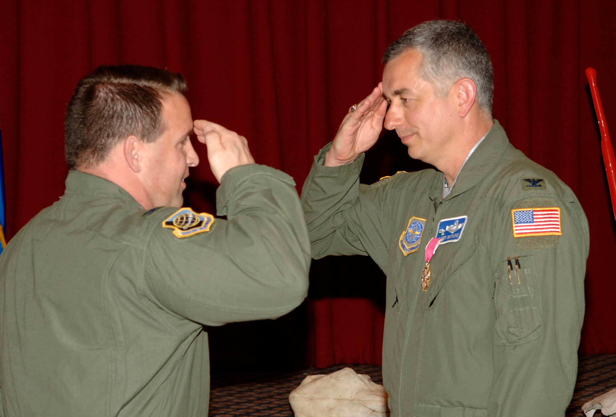 FAIRCHILD AIR FORCE BASE, Wash. – Col. Thomas Sharpy (left), 92nd Air Refueling Wing commander, is saluted by Col. Roger Watkins, 92nd Air Refueling Wing vice commander, after being presented with the Legion of Merit at Club Fairchild here June 14. Colonel Watkins was awarded the Legion of Merit for his service to the Fairchild community as the 92nd ARW vice commander. (U.S. Air Force photo / Staff Sgt. Chad Watkins)