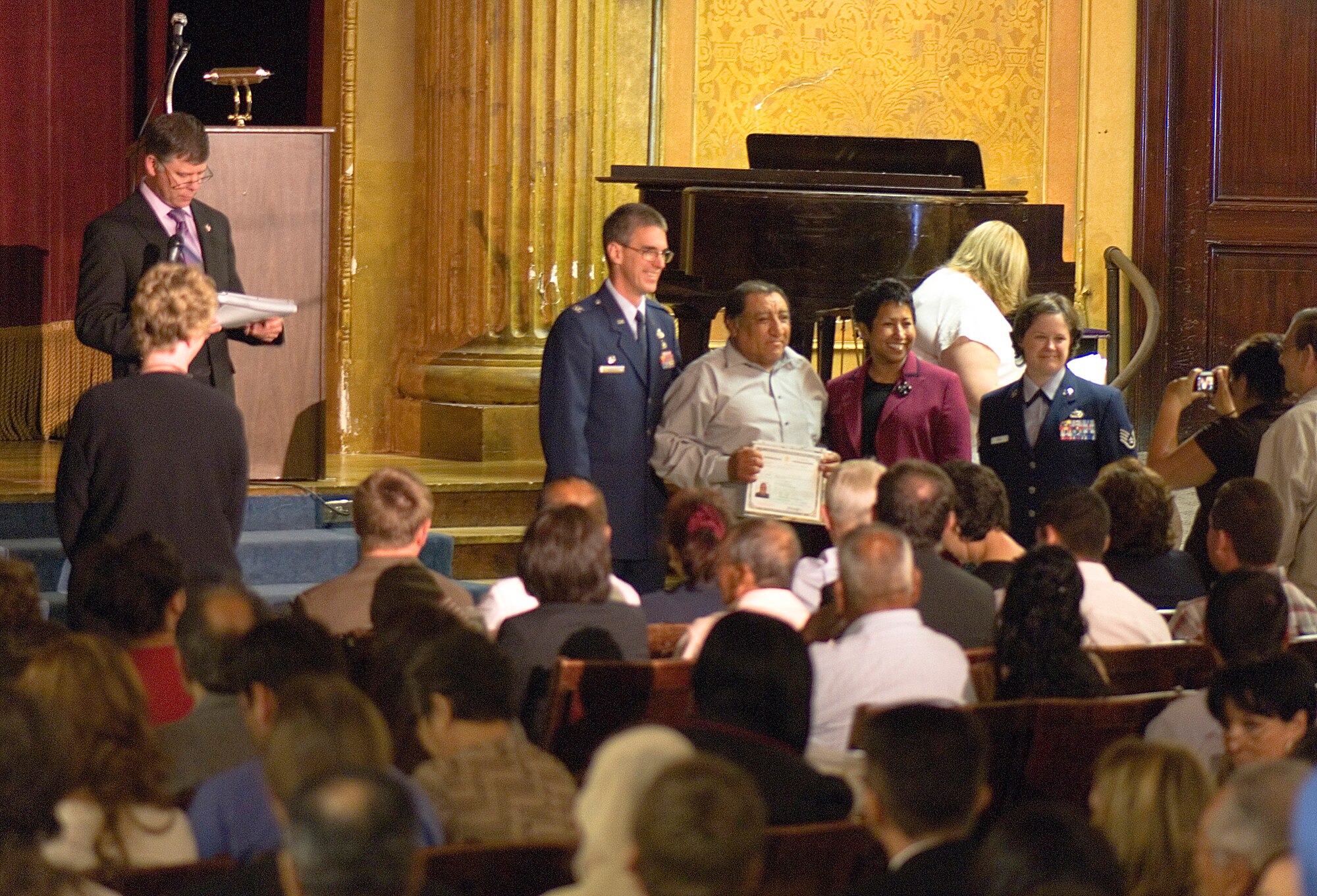 FAIRCHILD AIR FORCE BASE, Wash. – Col. Robert Egbert, 92nd Maintenance Group commander, and Staff Sgt. Connie Bias, 92nd Air Refueling Wing Public Affairs, pose for a photo with newly naturalized citizens during a Naturalization Ceremony at the Masonic Temple in Spokane, Wash., June 13. (U.S. Air Force photo / Airman 1st Class Joshua Chapman)