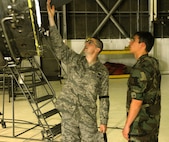MINOT AIR FORCE BASE, N.D. -- 2nd Lt. Justin Shetter, 5th Maintenance Squadron, shows Air Force Academy cadet Blake Horrell, the inner workings of a B-52H Stratofortress engine at the flight's inspection section June 16 here. The cadets are here as part of the Operation Air Force Third Lieutenant course. (U.S. Air Force photo by Airman 1st Class Benjamin Stratton)