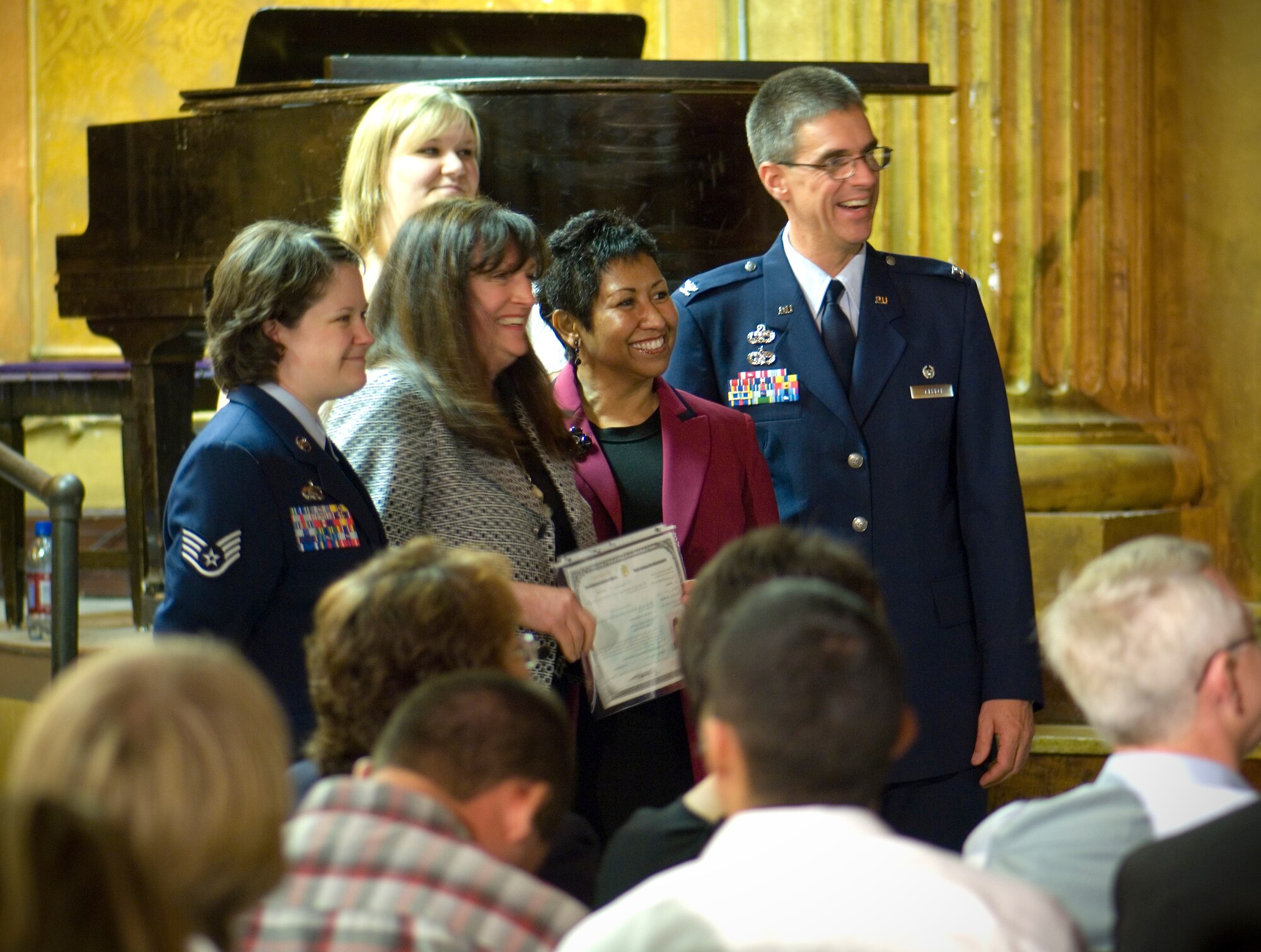 FAIRCHILD AIR FORCE BASE, Wash. – Col. Robert Egbert, 92nd Maintenance Group commander, and Staff Sgt. Connie Bias, 92nd Air Refueling Wing Public Affairs, pose for a photo with newly naturalized citizens during a Naturalization Ceremony at the Masonic Temple in Spokane, Wash., June 13. (U.S. Air Force photo / Airman 1st Class Joshua Chapman)