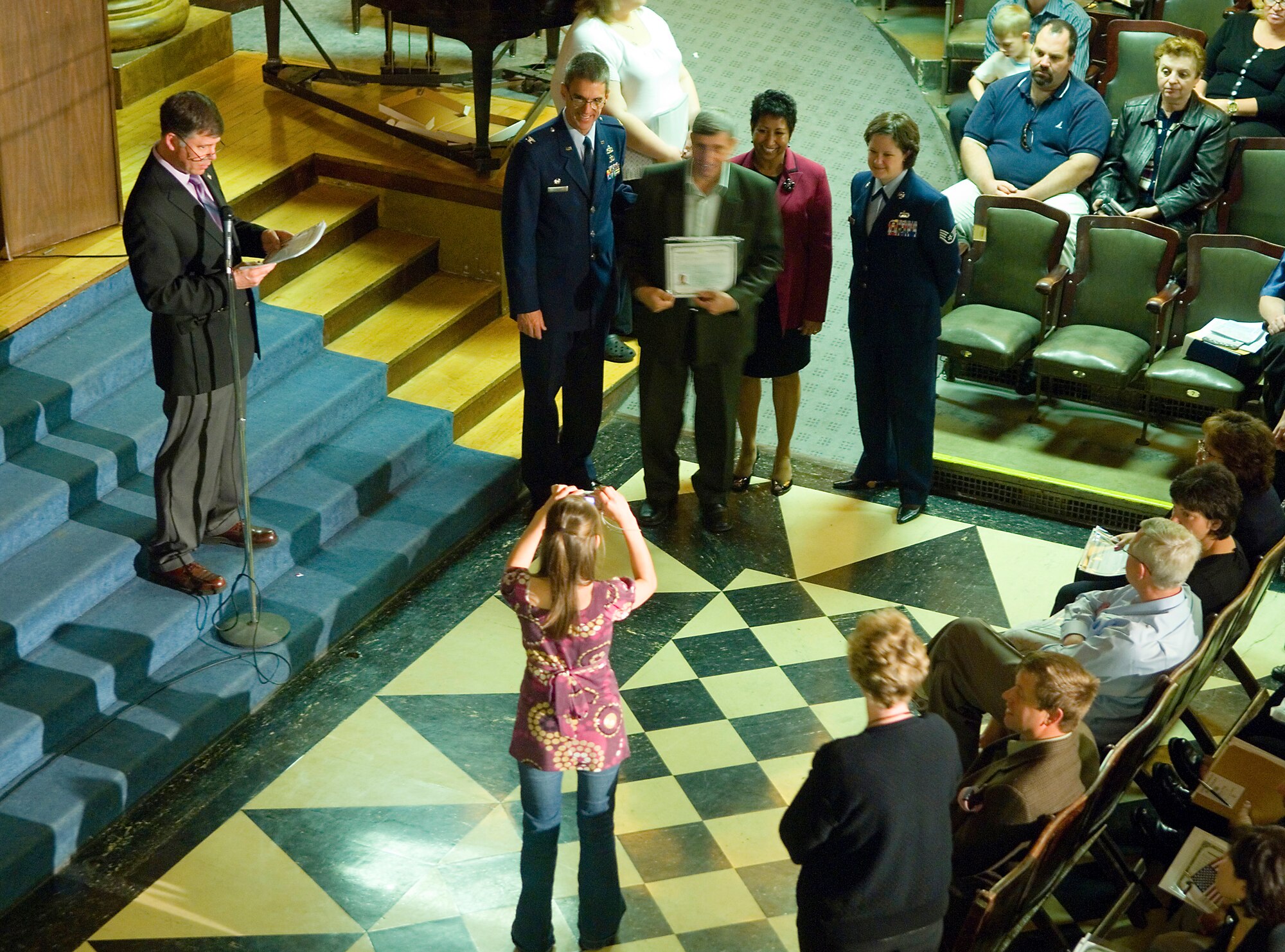 FAIRCHILD AIR FORCE BASE, Wash. – Col. Robert Egbert, 92nd Maintenance Group commander, and Staff Sgt. Connie Bias, 92nd Air Refueling Wing Public Affairs, pose for a photo with newly naturalized citizens during a Naturalization Ceremony at the Masonic Temple in Spokane, Wash., June 13. (U.S. Air Force photo / Airman 1st Class Joshua Chapman)