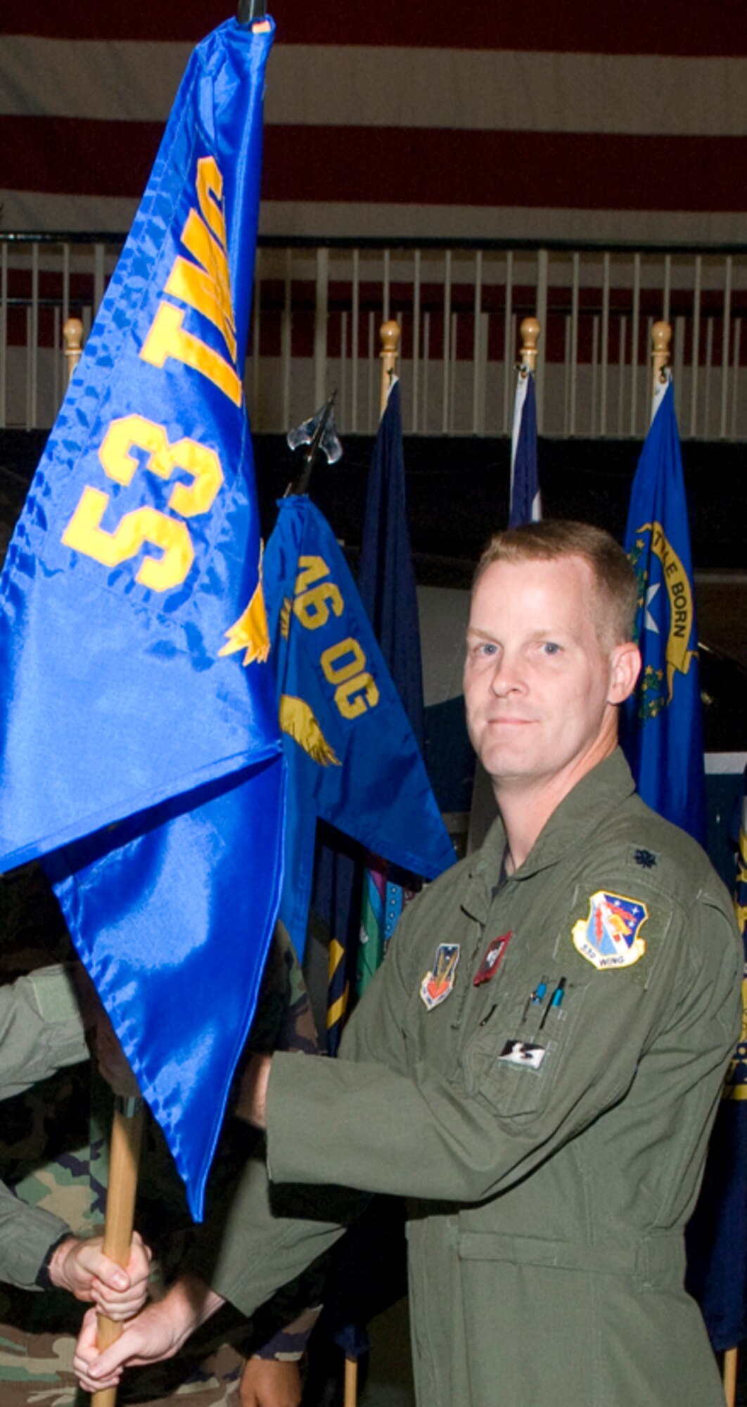 Lt. Col. William Singletary accepts the guidon as the new commander of the Operational Flight Program Combined Test Force June 13 at the Air Armament Museum at Eglin Air Force Base, Fla.  The unit now is commanded by the 53d Wing.  The OFP CTF alternates commanders between the 46th Test Wing and the 53d Wing.  Lt. Col. David Evans from the 46th relinquished command.