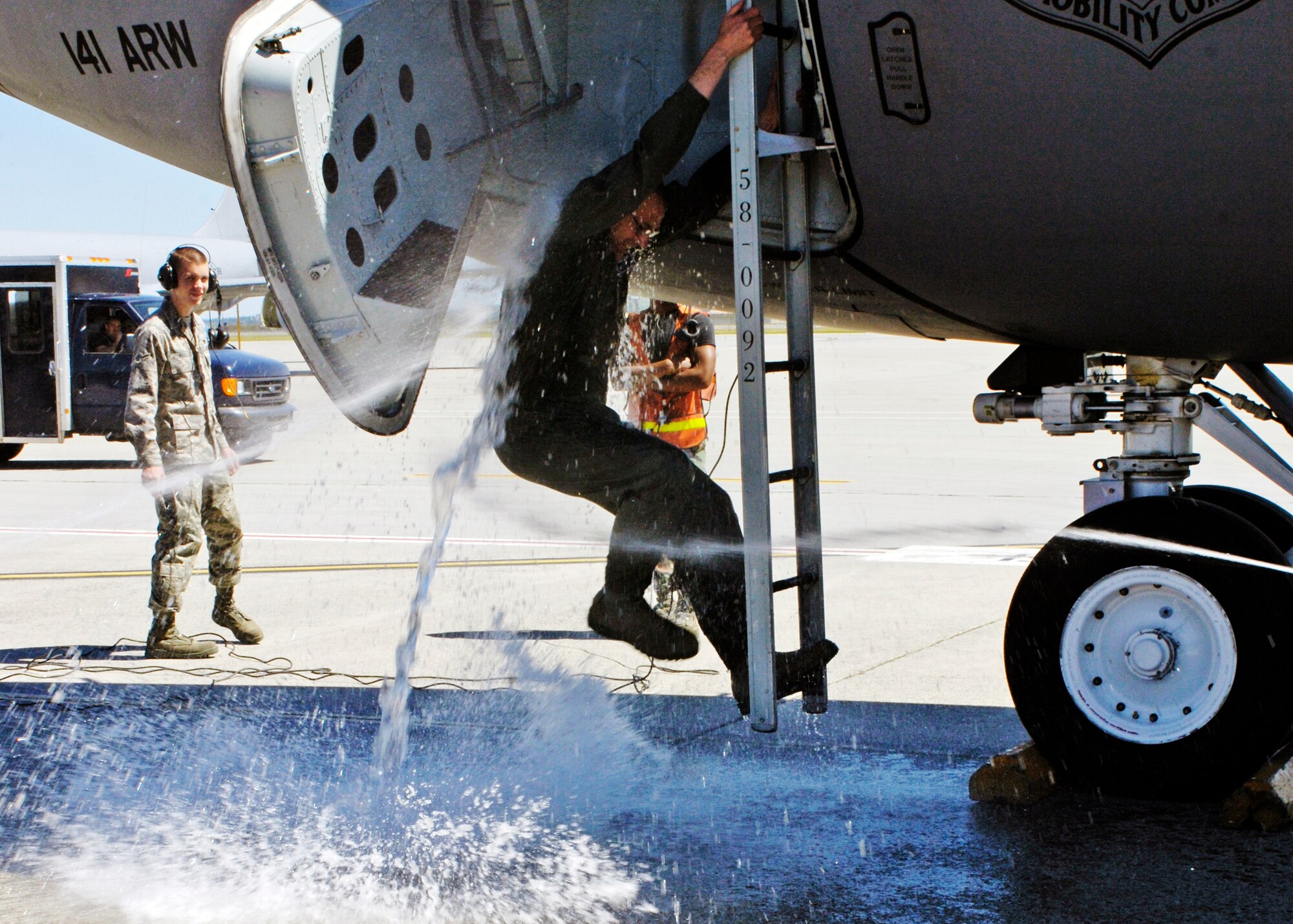 FAIRCHILD AIR FORCE BASE, Wash. – Col. Mark Melville, 92nd Operations Group commander, gets drenched by family and friends while exiting a KC-135 Stratotanker for the last time as the 92nd OG commander here June 16. (U.S. Air Force photo / Airman 1st Class Melissa Barnett)