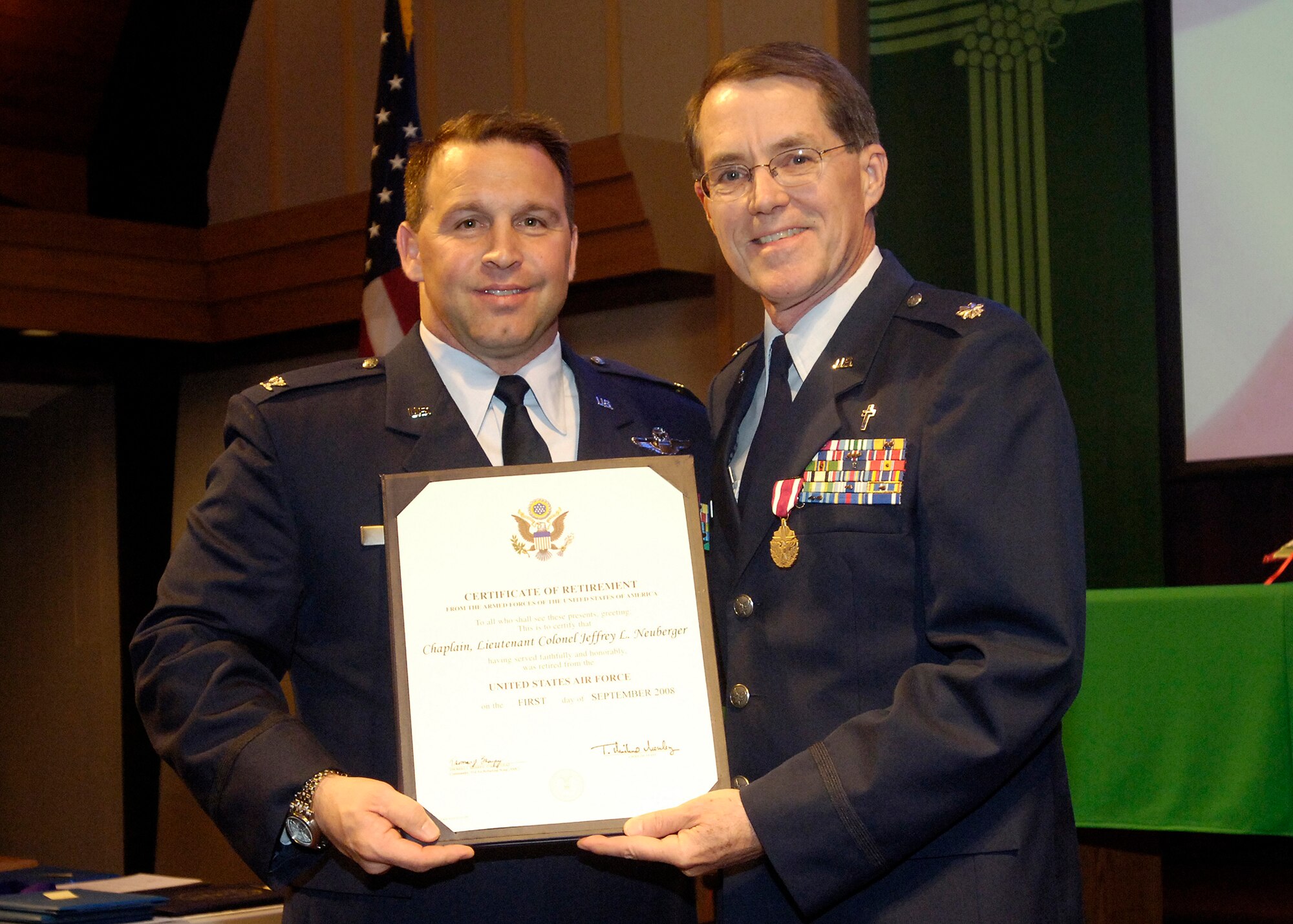 FAIRCHILD AIR FORCE BASE, Wash. – Col. Thomas Sharpy, 92nd Air Refueling Wing commander, presents Chaplain Jeff Neuberger, 92nd Air Refueling Wing chaplain, with a certificate of retirement during his retirement ceremony at the Base Chapel June 13. (U.S. Air Force photo / Senior Airman Eunique Stevens)
