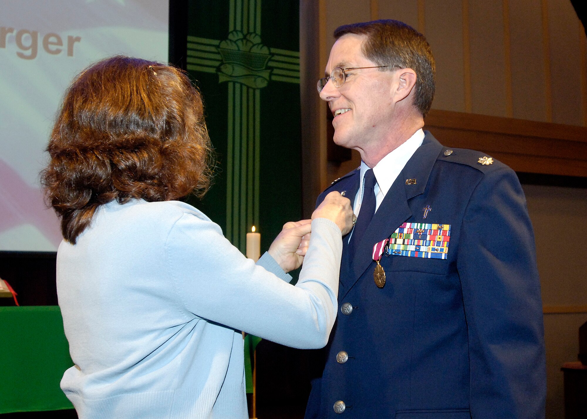 FAIRCHILD AIR FORCE BASE, Wash. – Kathryn Neuberger places the retirement pin on her husband Chaplain Jeff Neuberger, 92nd Air Refueling Wing chaplain, during his retirement ceremony at the Base Chapel June 13. (U.S. Air Force photo / Senior Airman Eunique Stevens)