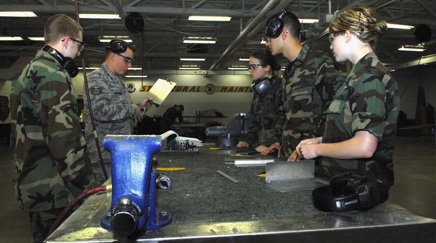 MINOT AIR FORCE BASE, N.D. -- Staff Sgt. Adam Johnson, 5th Maintenance Group, shows Air Force Academy cadets properly riveted aircraft panels at the sheet metal and fabrication flight here June 16. The cadets are here as part of the Operation Air Force Third Lieutenant course.(U.S. Air Force photo by Airman 1st Class Benjamin Stratton)