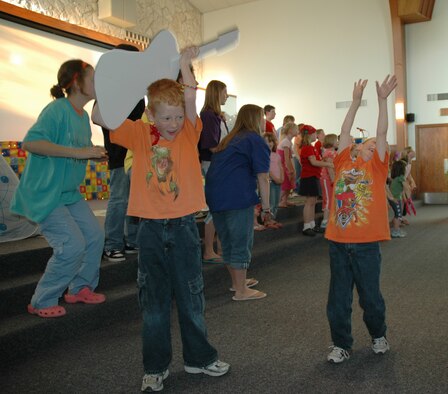 Vacation Bible School students sing and dance in the base chapel sanctuary during the five-day VBS finale. (U.S. Air Force photo/Airman 1st Class Dillon White)