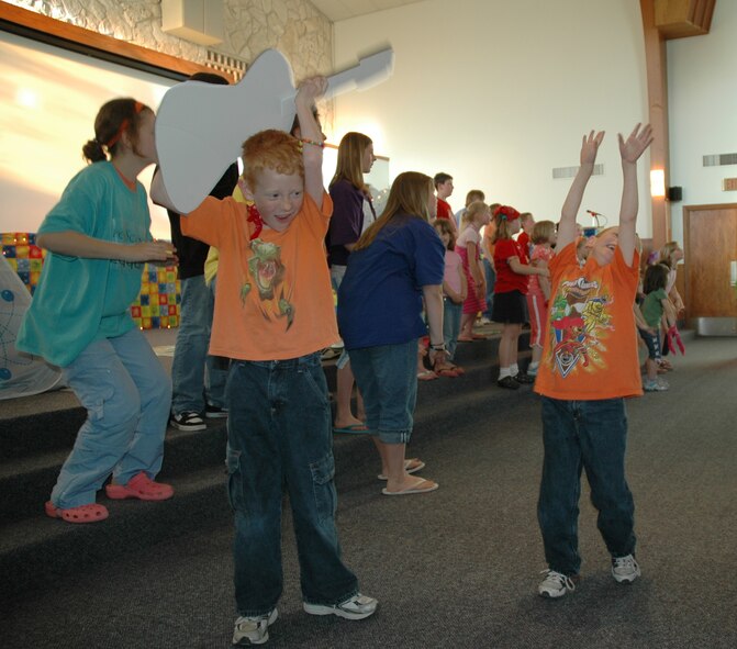 Vacation Bible School students sing and dance in the base chapel sanctuary during the five-day VBS finale. (U.S. Air Force photo/Airman 1st Class Dillon White)