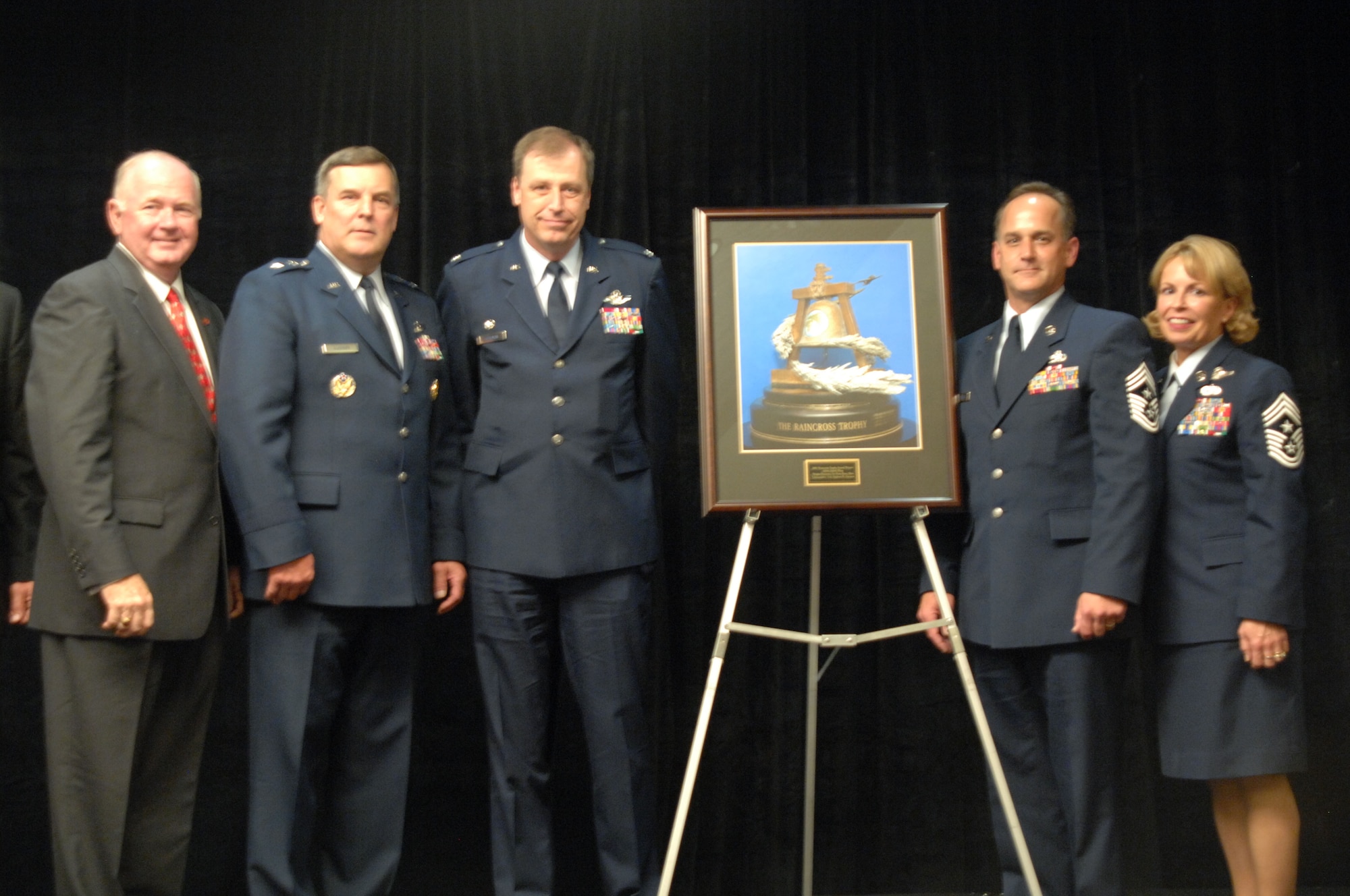 From left to right, Lieutenant General Jimmy Sherrard (ret), Major General Bob Duignan, Commander, Fourth Air Force, Colonel Stephen Goeman, and Command Chief Master Sergeant Aaron Mouser with the 445th Airlift Wing from Wright Patterson AFB, Ohio, along with Fourth Air Force Command Chief Master Sergeant Patricia Thornton, with the 2007 Raincross Trophy Award presented at the 10th Annual Raincross Trophy Dinner held at the Riverside Convention Center in Riverside, California, on June 11, 2008.(USAF photo by Senior Master Sergeant Kim Allain)(released)