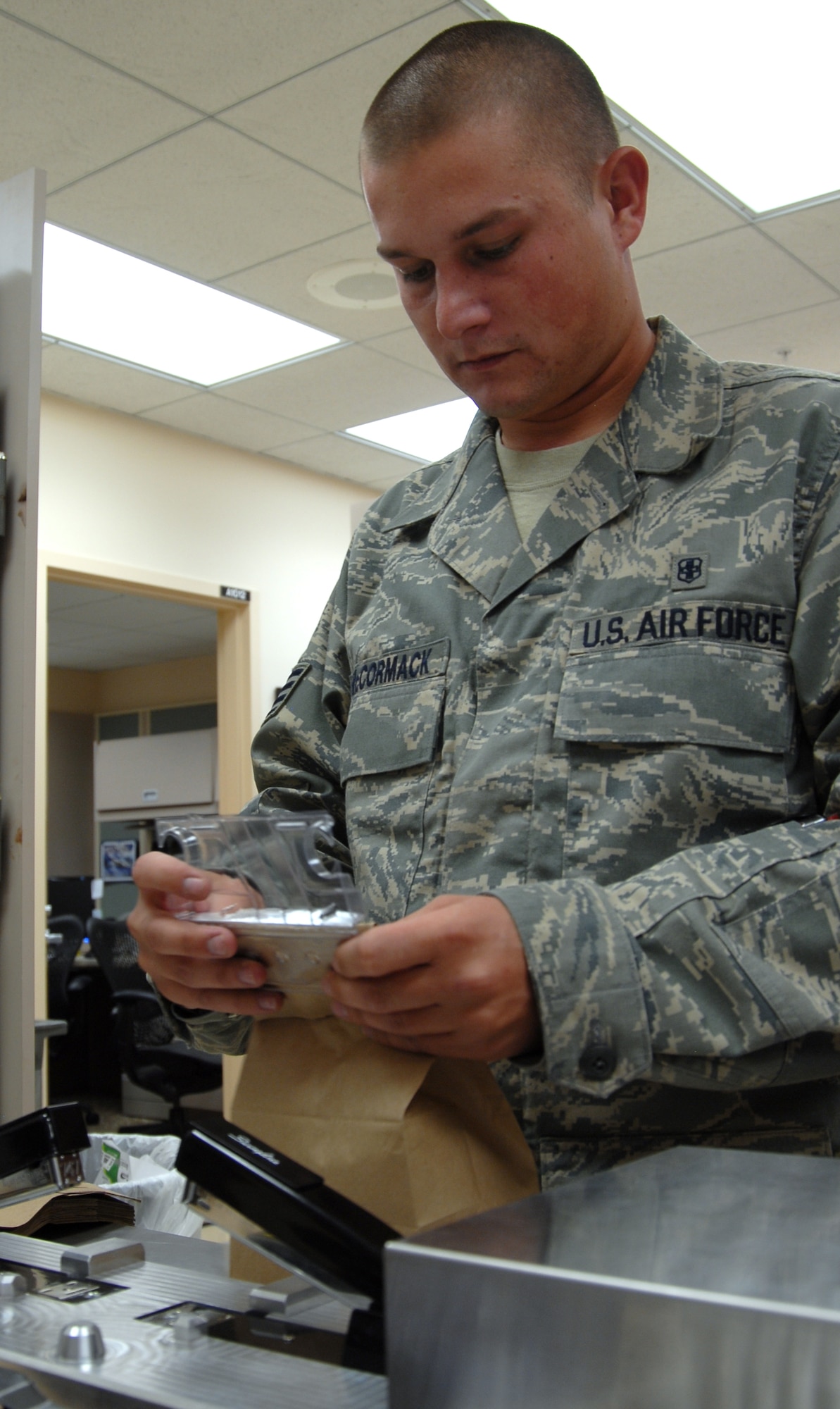 Staff Sgt. Jason McCormack, 95th Medical Support Squadron pharmacy technician, packages refilled medication for the automated prescription machine located at the Base Exchange. The APM is available to all TriCare patients during BX operating hours. (Air Force photo by Senior Airman Stacy Sanchez)