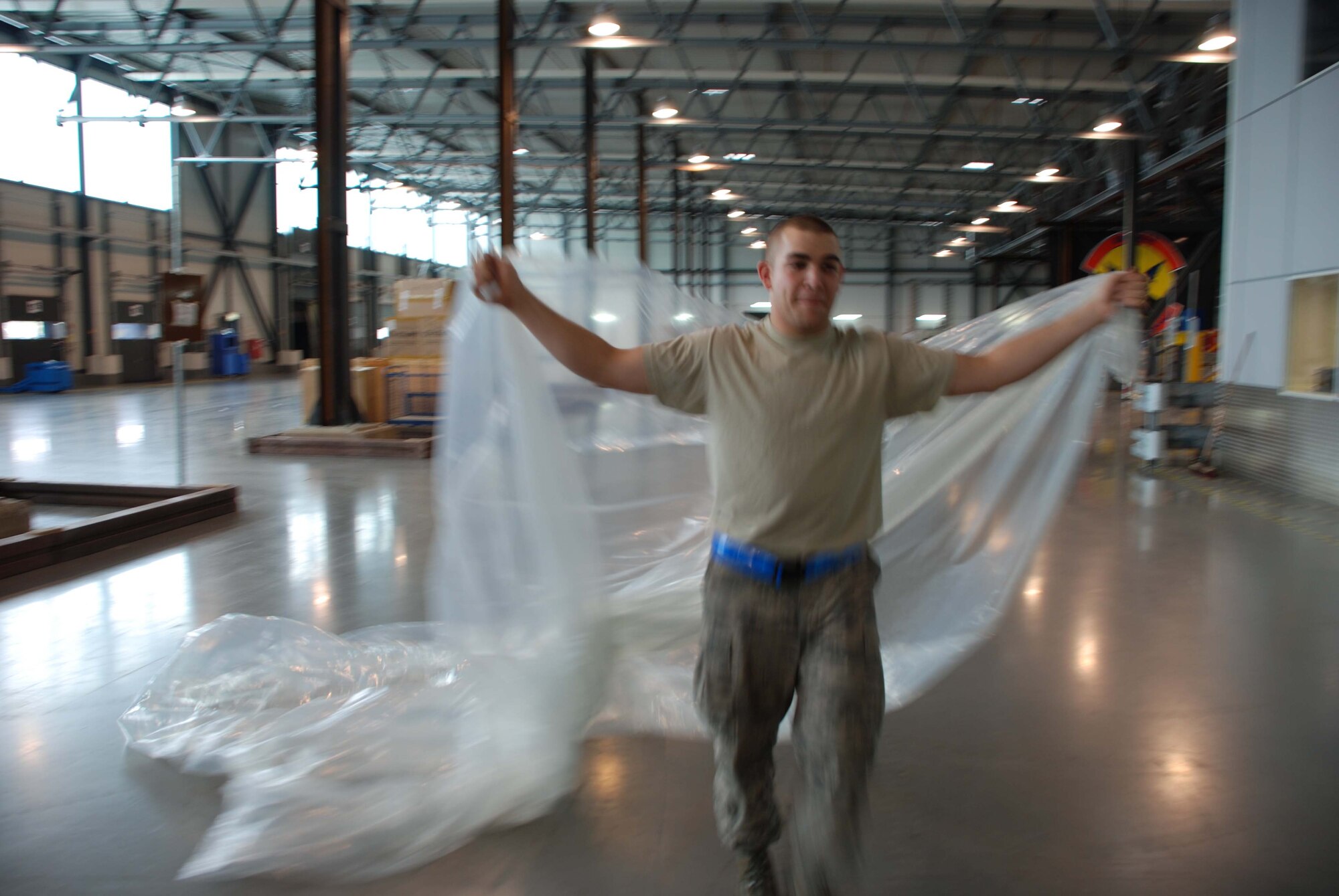 RAMSTEIN AIR BASE, Germany -- Airman 1st Class Justin Boyanton, 723rd Air Mobility Squadron air transportation apprentice, covers pallets with plastic for weather protection here May 27. Airman Boyanton worked alongside 459th Air Refueling Wing members who spent their annual tour here in support of airport operations at U.S. Air Forces in Europe headquarters. (U.S. Air Force photo/Tech. Sgt. Amaani Lyle)