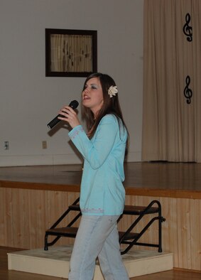 Airman 1st Class Jolene Bullock, 341st Missile Maintenance Squadron, performs "Son of a Preacher Man" during the Wing It Theater American Bandstand-like performance June 14. Airman Bullock continued to perform her selection acapella, after the music to her song cut out. The audience lent a hand by clapping to keep time. (U.S. Air Force photo/Airman 1st Class Emerald Ralston)