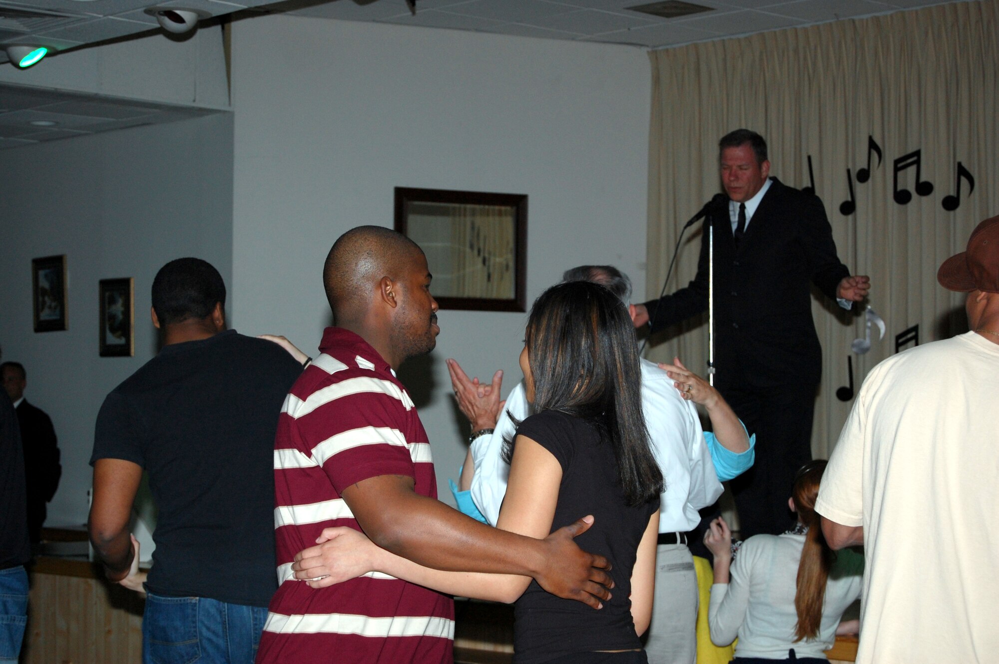 Chief Master Sgt. Steve Sargent, 341st Space Wing command chief, performs "In the Still of the Night" and invited members from the audience to come to the dance floor. The performance was part of an American Bandstand-like tribute put on by Wing It Theater, Malmstrom's theater group, at the Grizzly Bend Club June 14. (U.S. Air Force photo/Airman 1st Class Emerald Ralston)