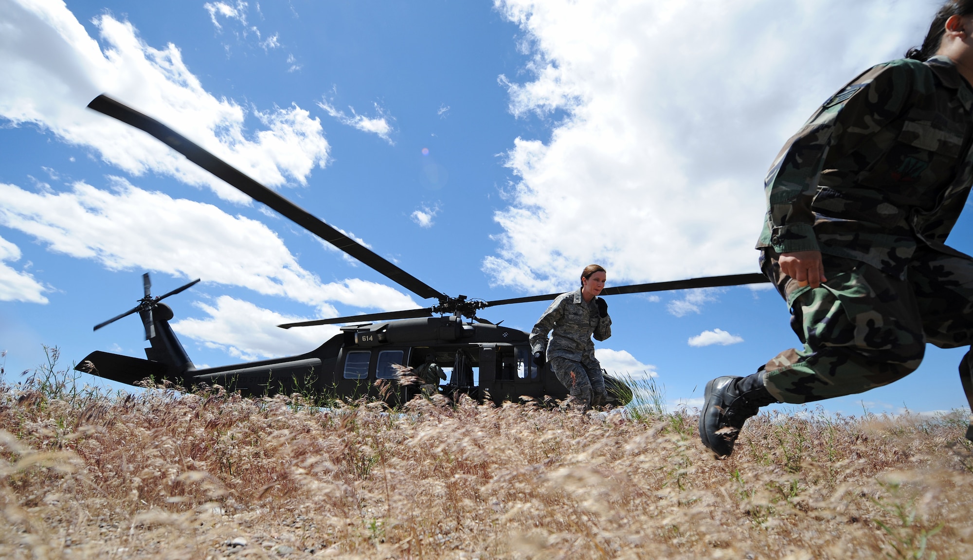 MOUNTAIN HOME AIR FORCE BASE, Idaho - First responders exit a UH-60 Blackhawk helicopter after flying over the Saylor Creek Range to survey the area for survivors during an emergency management exercise involving a simulated F-15E Strike Eagle crash June 10. The one day, ungraded exercise gave Gunfighters a chance to ask questions and familiarize themselves with how to respond to a major accident in a controlled situation. (U.S. Air Force photo/ Airman 1st Class Ryan Crane)