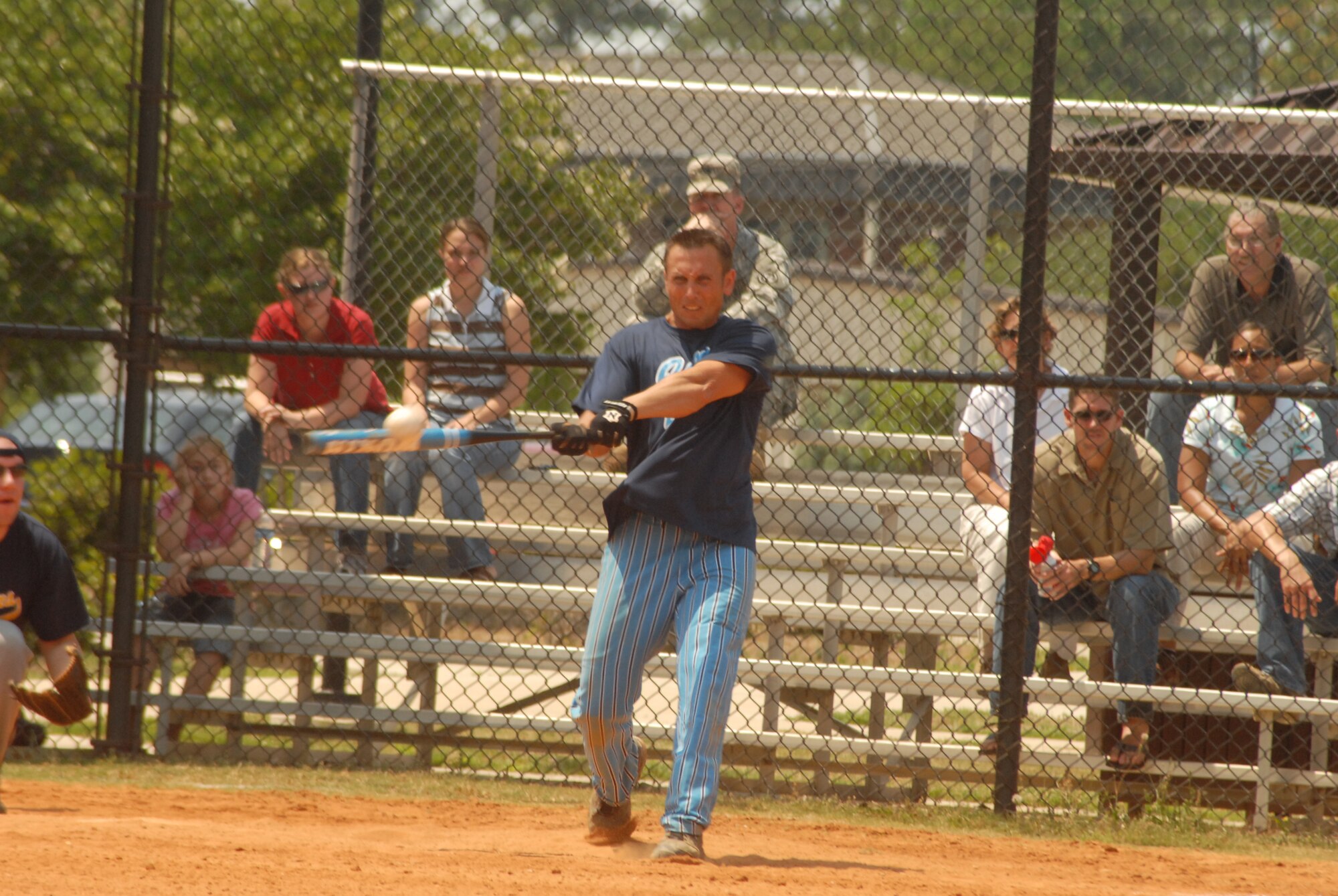 Brent Hobey, designated hitter for the Joint Communications Unit, finishes his swing during the Pope Intramural Softball Championship game June 13. Hobey had four RBIs in JCU's game one win. (U.S. Air Force Photo by Staff Sgt. Jon LaDue)