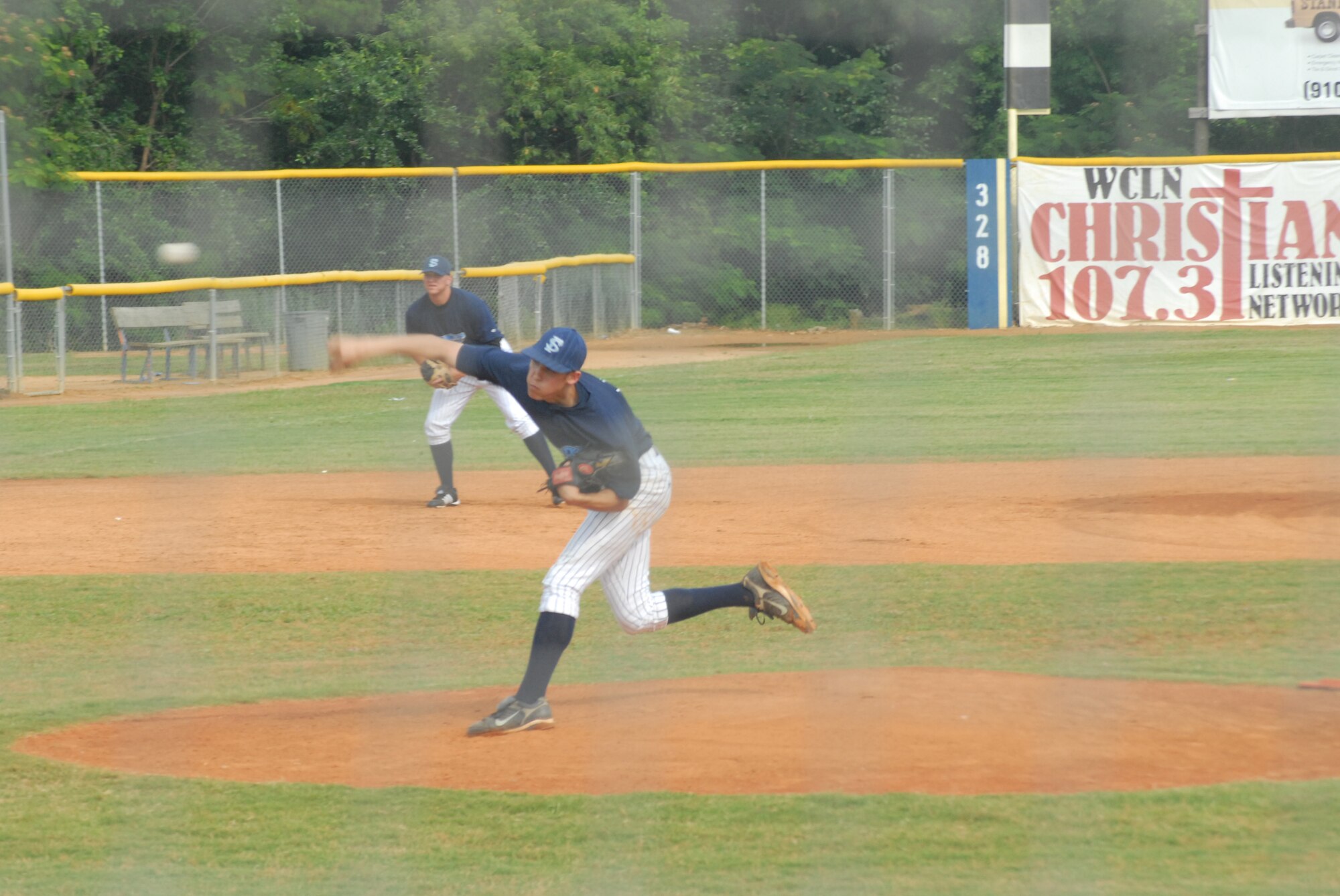 Cadet 3rd Class Mike Ruvolo, U.S. Air Force Academy, delivers a pitch for the Swampdogs during the first inning of June 15's game. Cadet Ruvolo pitches for the USAFA team and played for the Swampdogs for three weeks as part of the Academy’s Operation Air Force program, which allows cadets to shadow active-duty members for three weeks of their summer. Cadet Brad Pingel also played for the team. (U.S. Air Force Photo by 2nd Lt. Chris Hoyler)