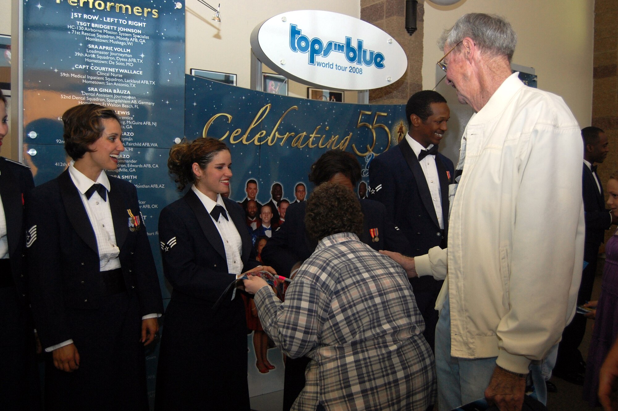 Tech. Sgt. Chandra Smith, command support staff with the 162nd Fighter Wing, Davis-Monthan Air Force Base, Ariz., and Senior Airman Gina Bauza, dental assistant journeyman with the 52nd Dental Squadron, Spangdahlem Air Base, Germany, sign autographs and meet attendees following the Tops in Blue "Deja Blue" performance at the Montana Expo Park June 15. (U.S. Air Force photo/Airman 1st Class Emerald Ralston)