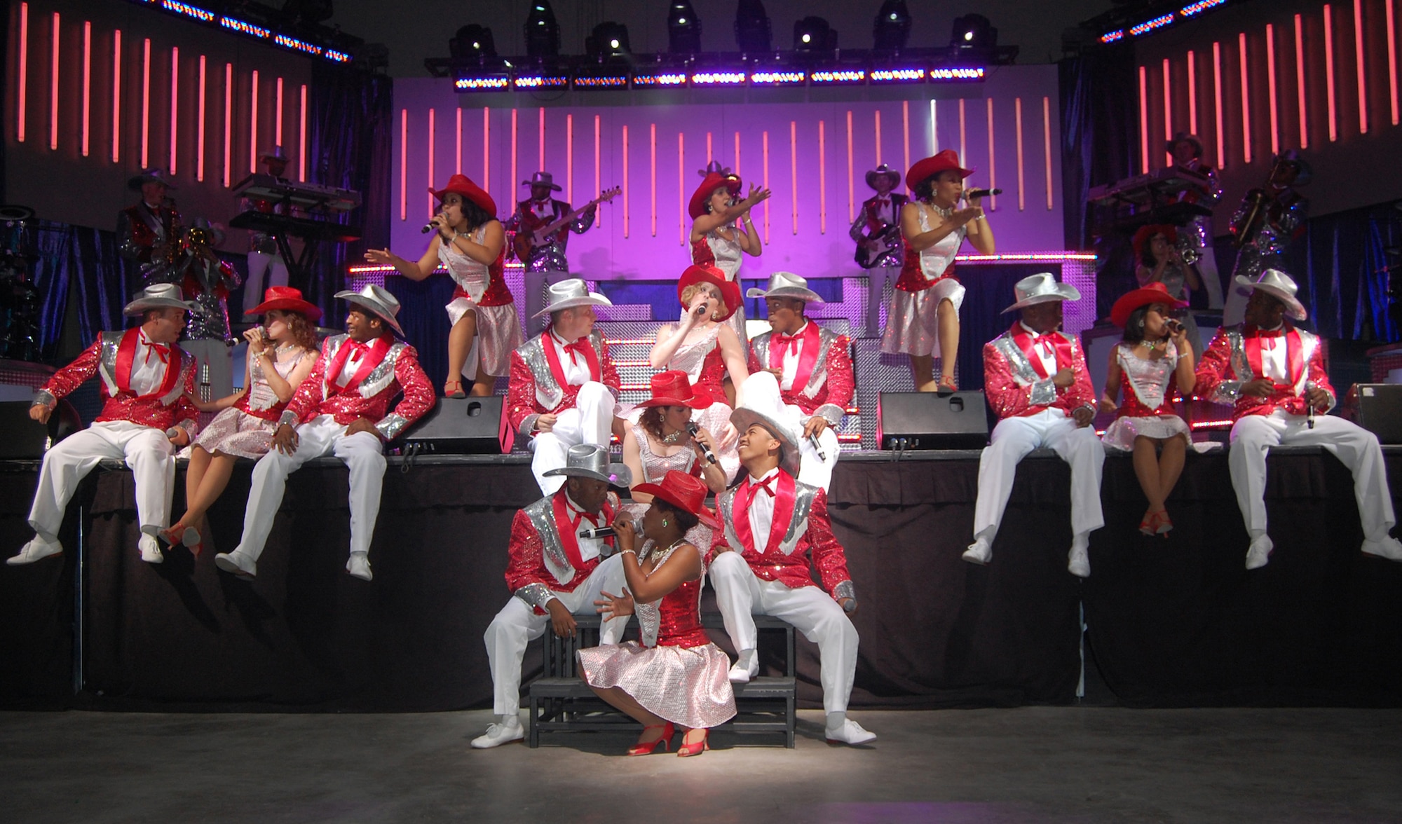 Members of Tops in Blue perform a country music segment of their "Deja Blue" performance at the Montana Expo Park June 15. Tops in Blue is a group of active-duty expeditionary entertainers that travel the world to perform wherever U.S. troops are stationed. (U.S. Air Force photo/Airman 1st Class Emerald Ralston)