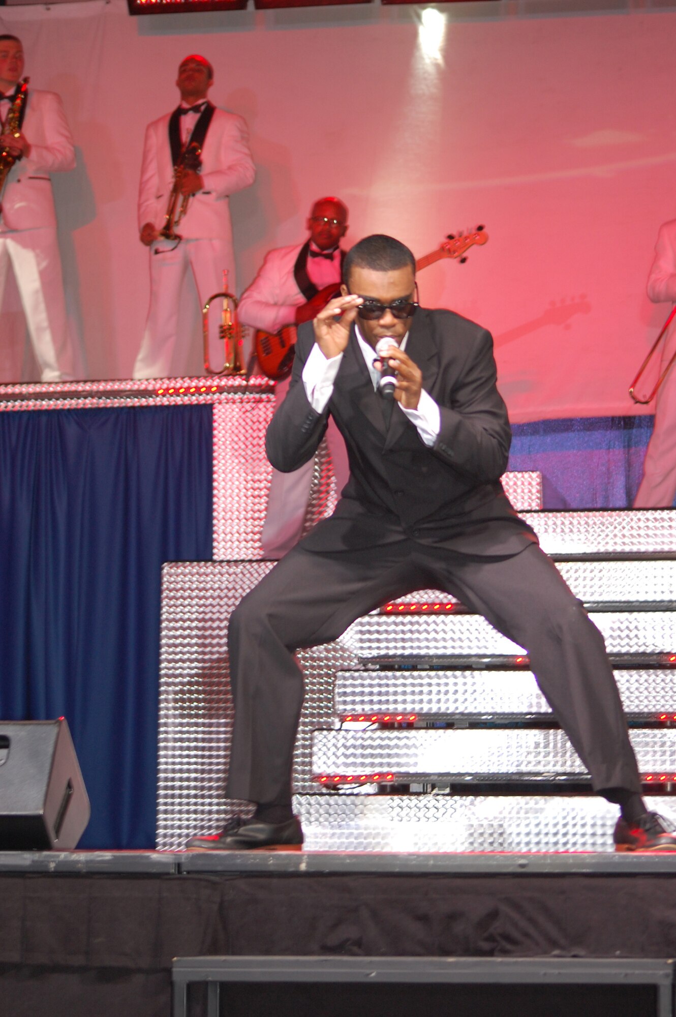 Airman 1st Class Barry Smith, security forces apprentice with the 1st Special Operations Security Forces Squadron, Hurlburt Field, Fla., performs the "Men in Black" theme song during a movie tribute during the Tops in Blue "Deja Blue" performance at the Montana Expo Park June 15. (U.S. Air Force photo/Airman 1st Class Emerald Ralston)