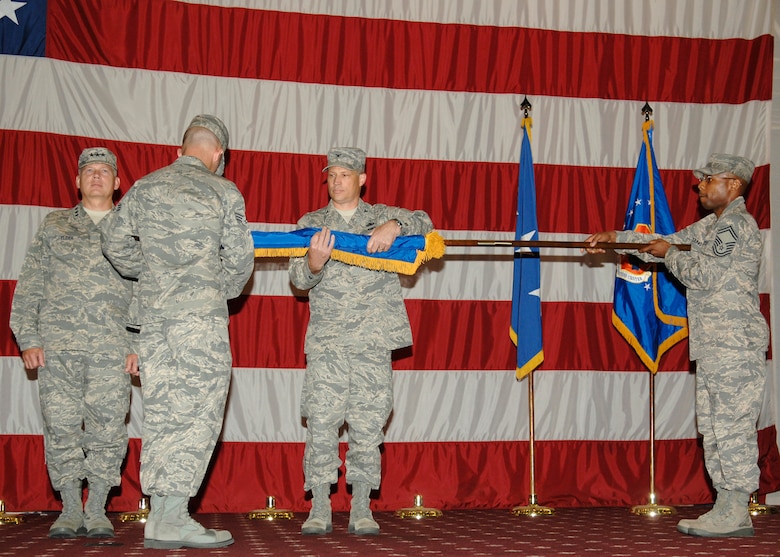 Col. Ward Heinke unfurls the 608th Air Force Network Operations Center flag during the Eighth Air Force redesignation ceremony June 10.  The 608th AFNOC was just one of the units that received a new name due to a recent reorganization involving 8AF units. (Air Force photo by Airman First Class Benjamin McWha)